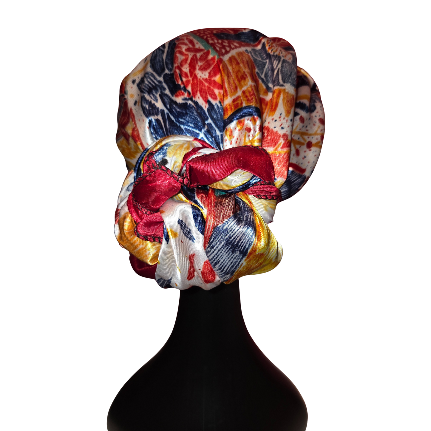 Colorful headscarf with floral patterns on a mannequin head against a white background
