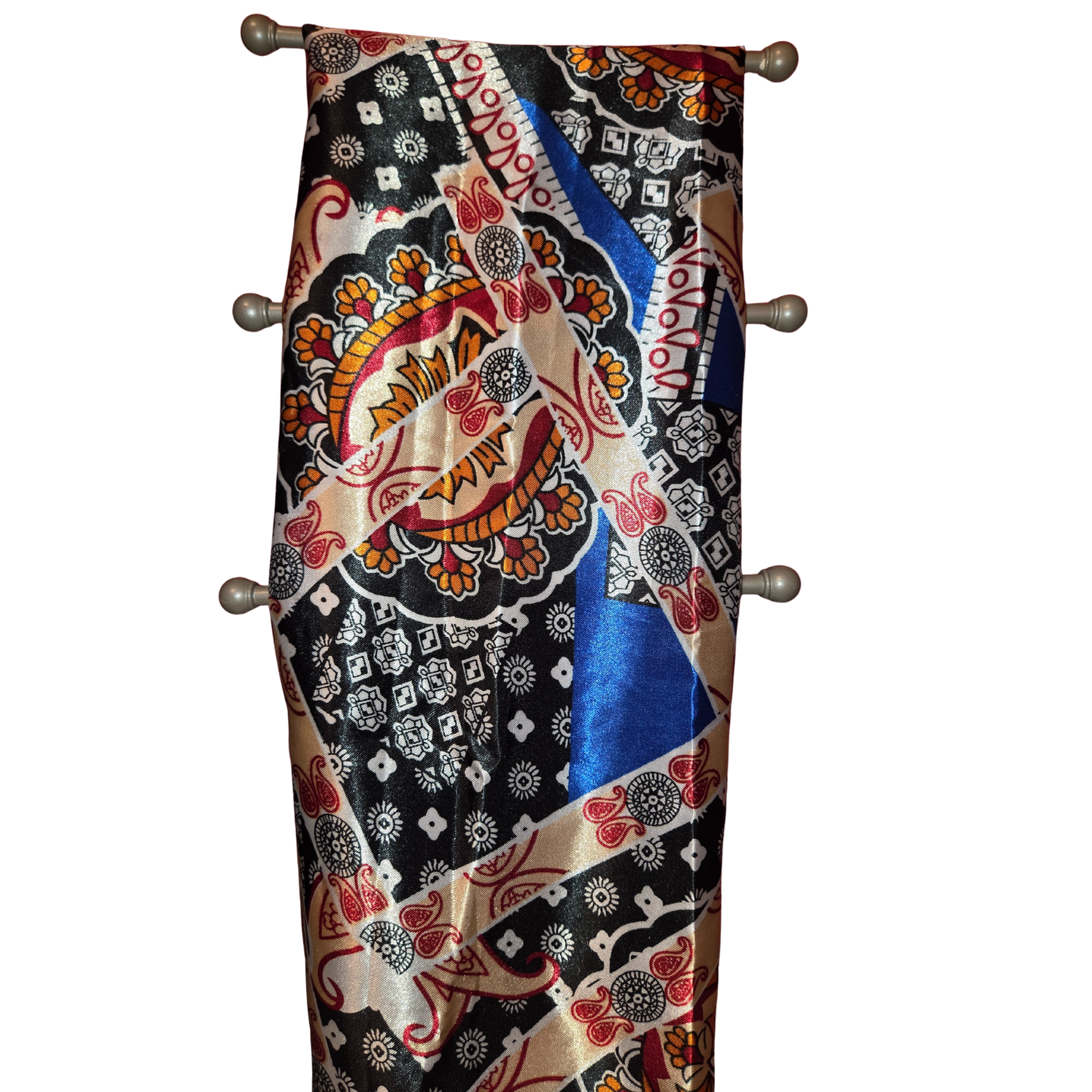 Colorful patterned scarf draped over a wooden rod on a white background