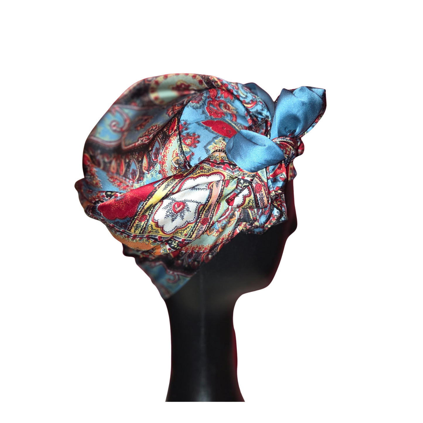 Colorful headscarf with a bow on a mannequin head against a white background