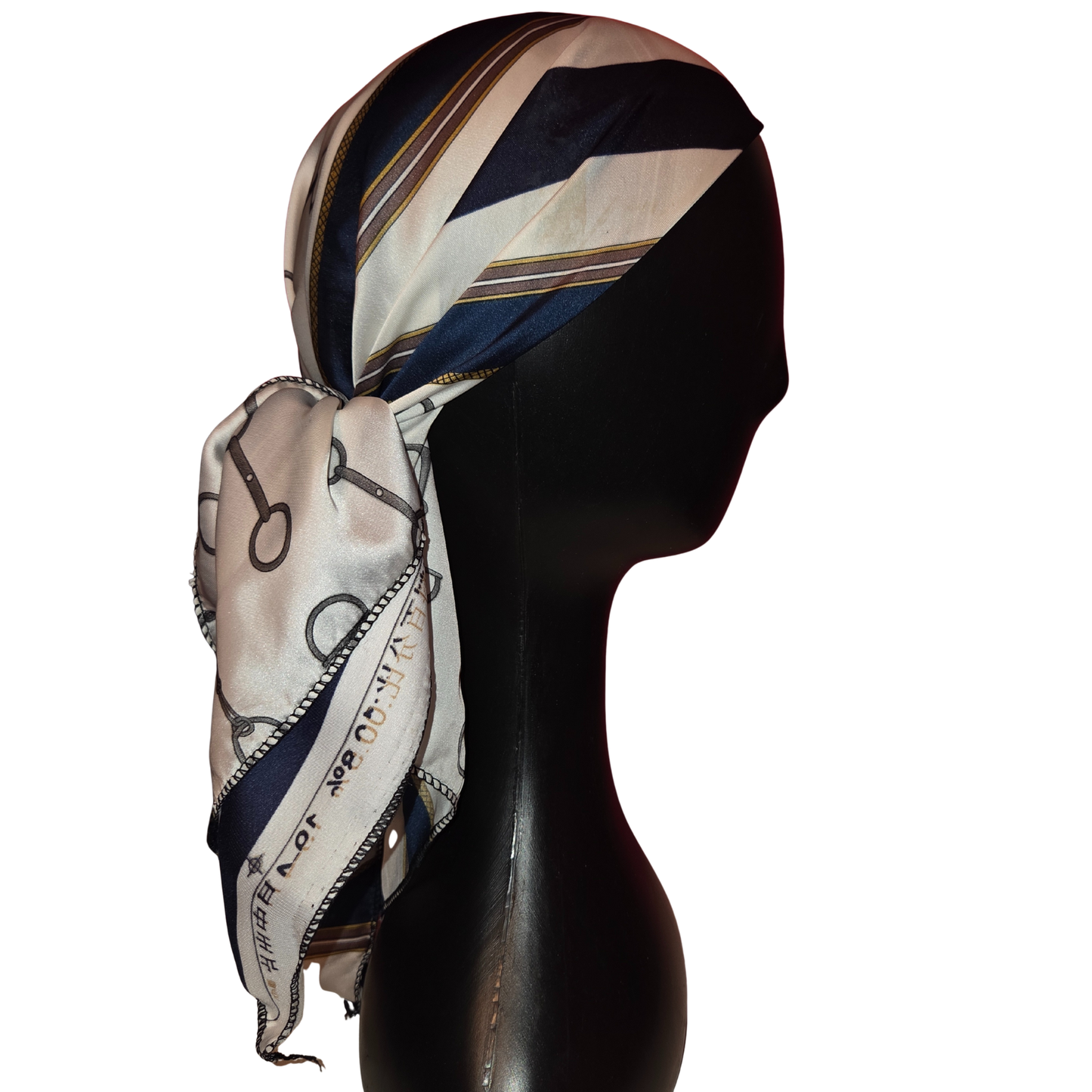 Mannequin head wearing a patterned scarf on a white background