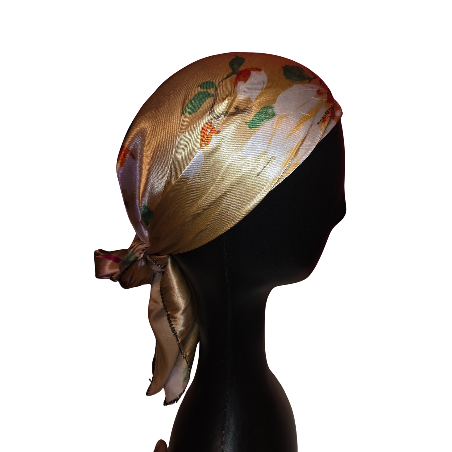 Silk scarf with floral design on a mannequin head against a white background