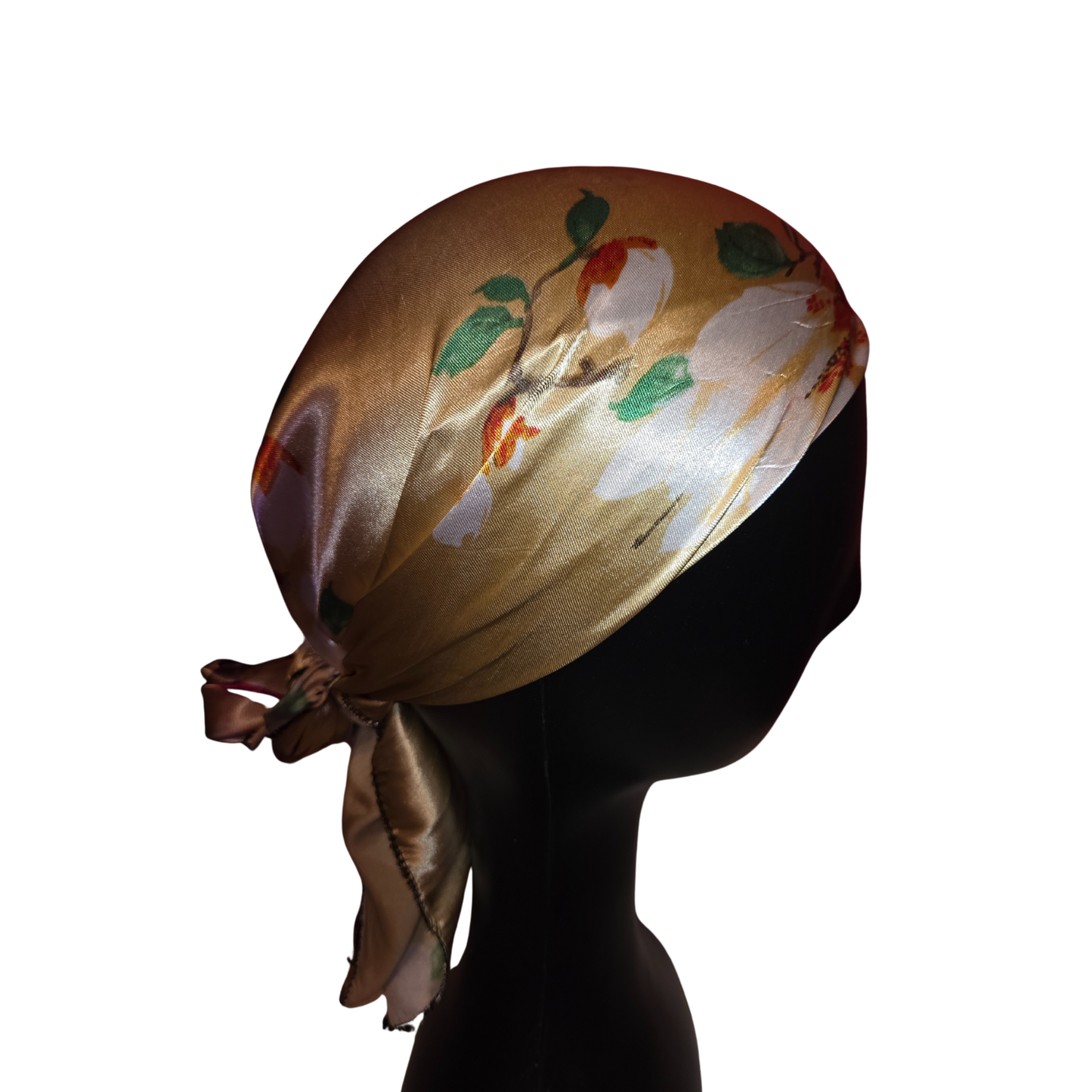 Silhouette of a mannequin head wearing a floral headscarf on a white background