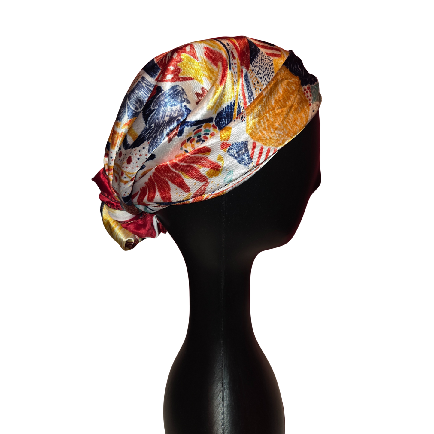 Colorful headscarf on a black mannequin head against a white background