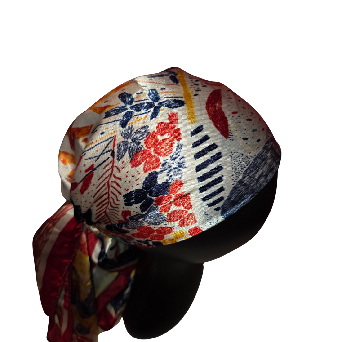 Colorful headscarf with floral and abstract patterns on a white background