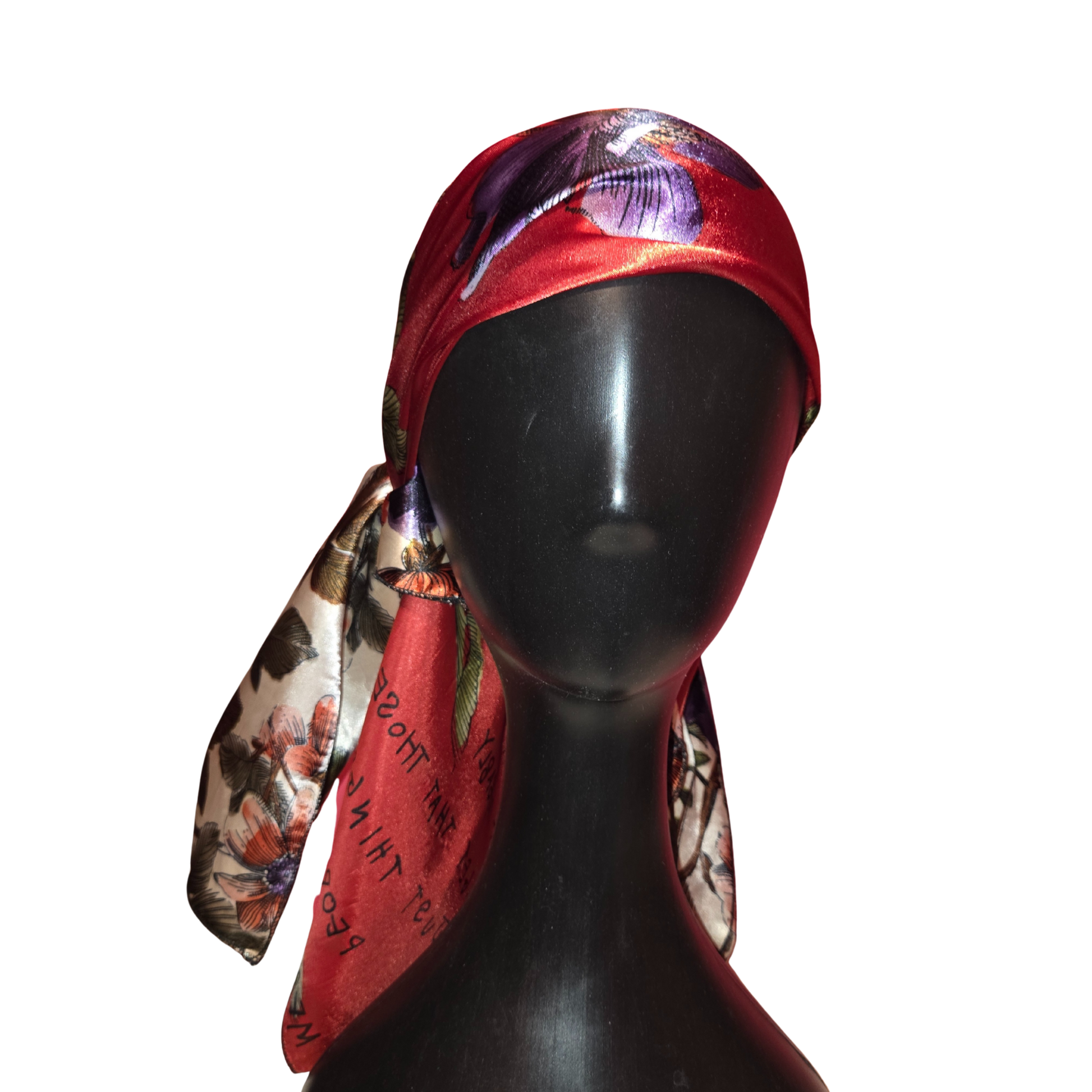 Mannequin head wearing a colorful headscarf on a white background
