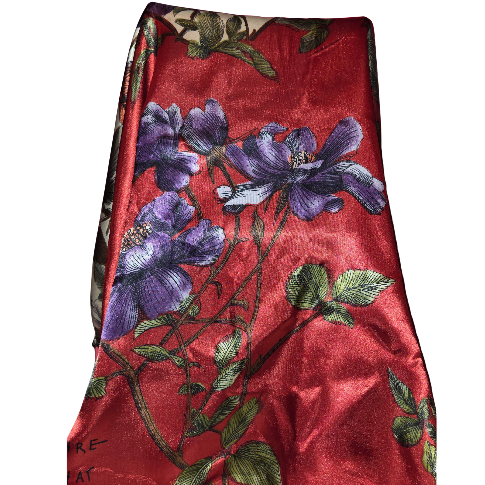 Red fabric with purple floral embroidery on a white background