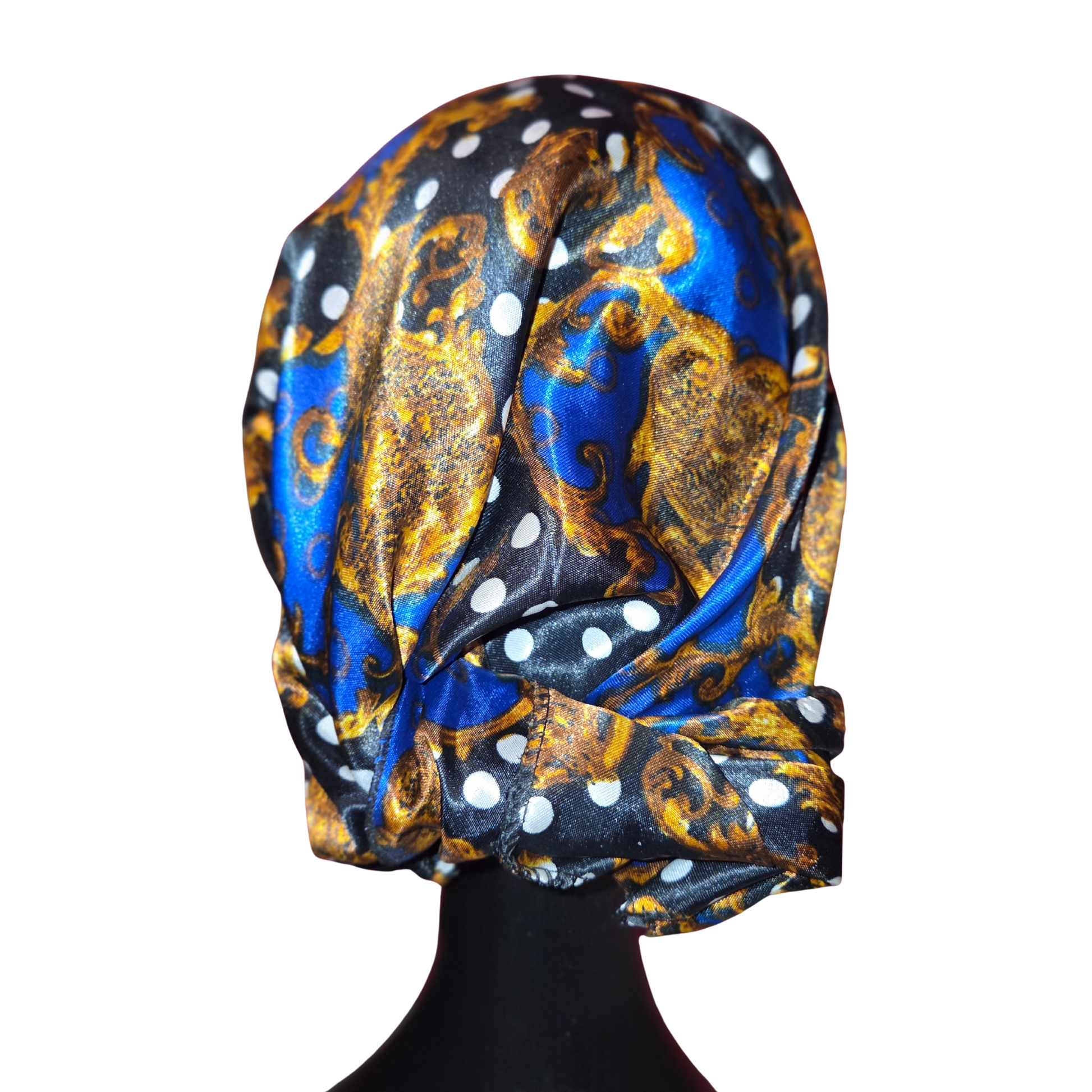 Patterned headscarf with blue, gold, and white design on a mannequin head against a white background