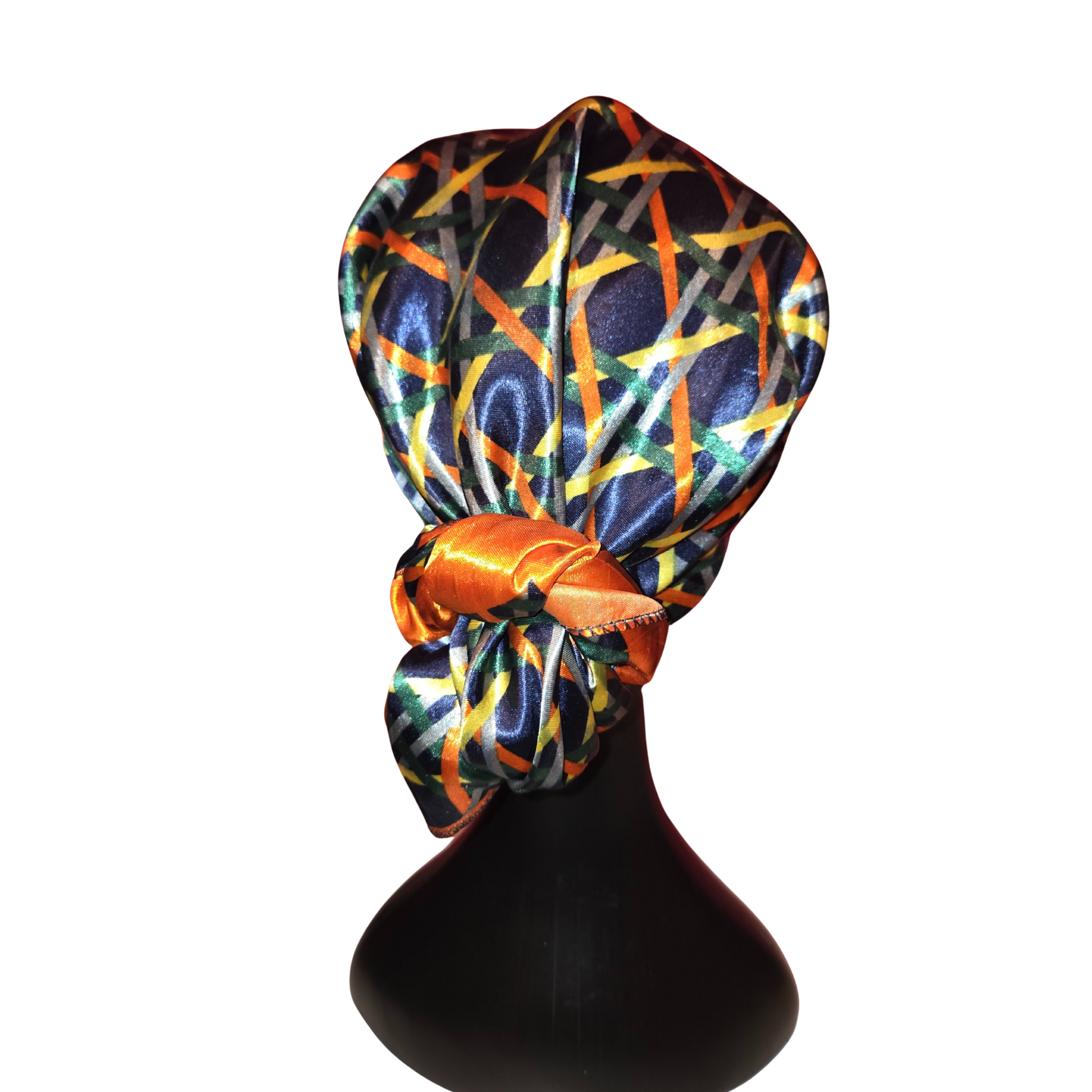 Colorful headscarf on a mannequin head against a white background