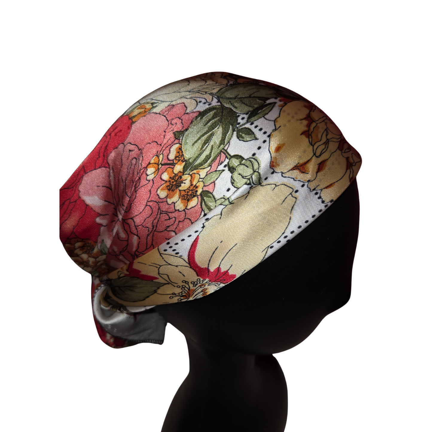 Floral and animal patterned headscarf on a mannequin head against a white background