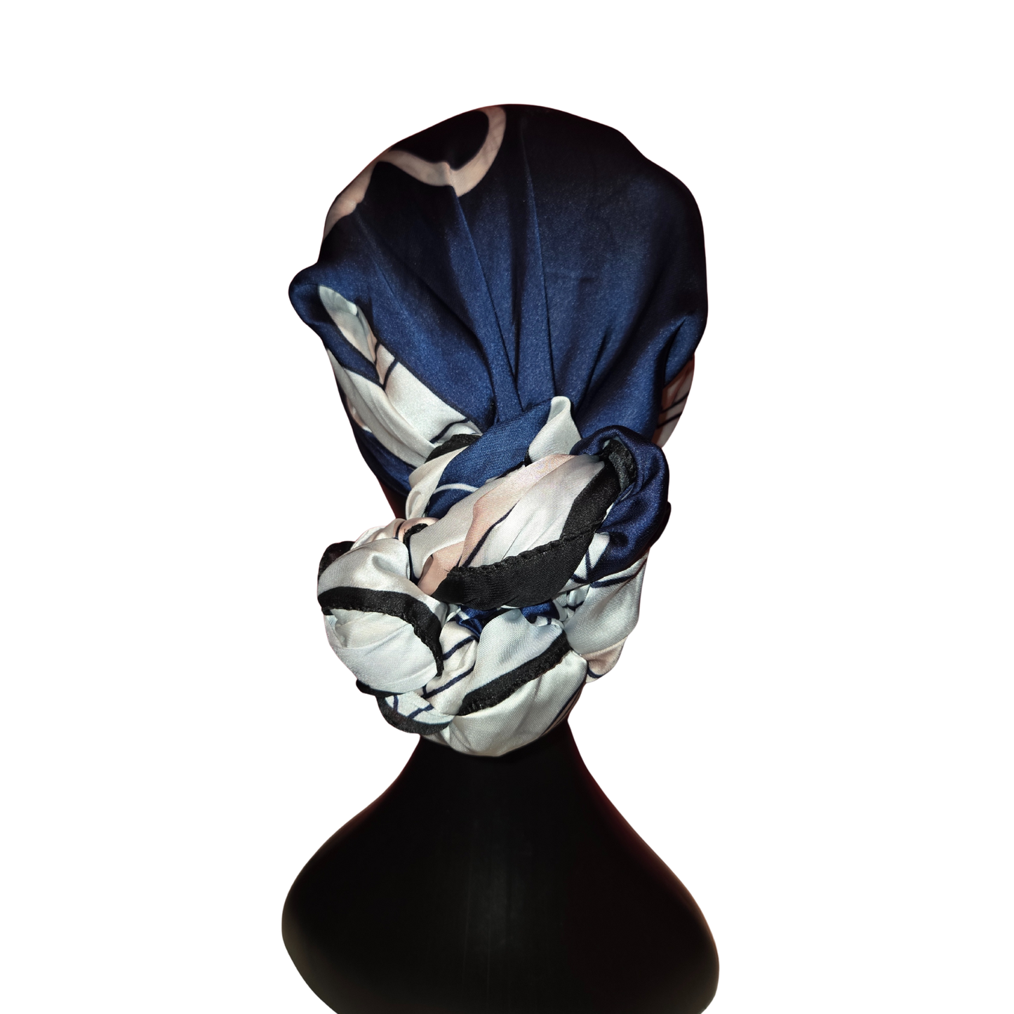 Blue and white patterned headscarf on a black mannequin head against a white background