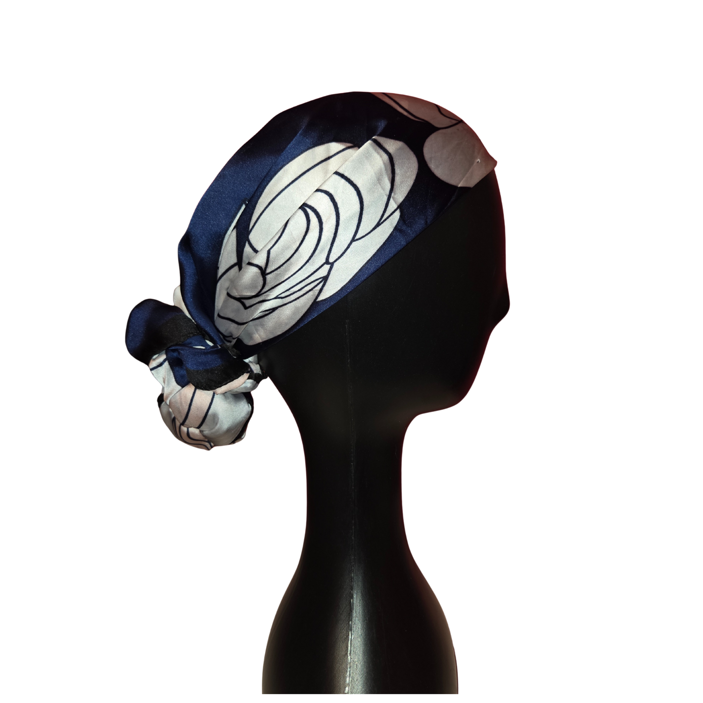 Mannequin head wearing a blue and white patterned headscarf on a white background
