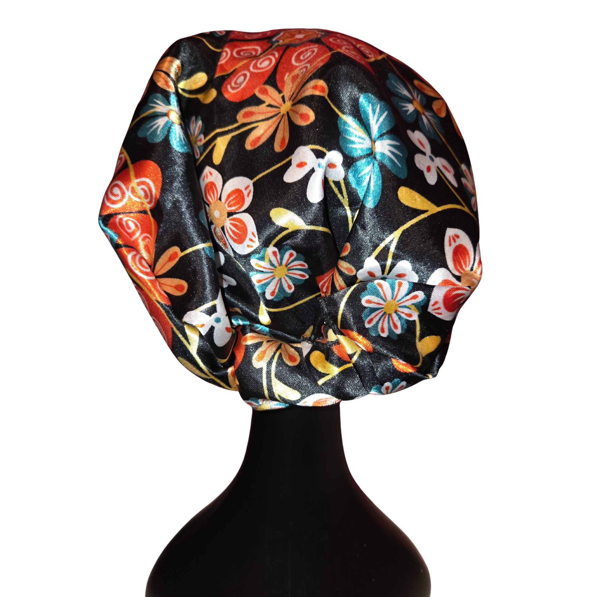 Colorful floral-patterned headscarf on a mannequin head against a white background