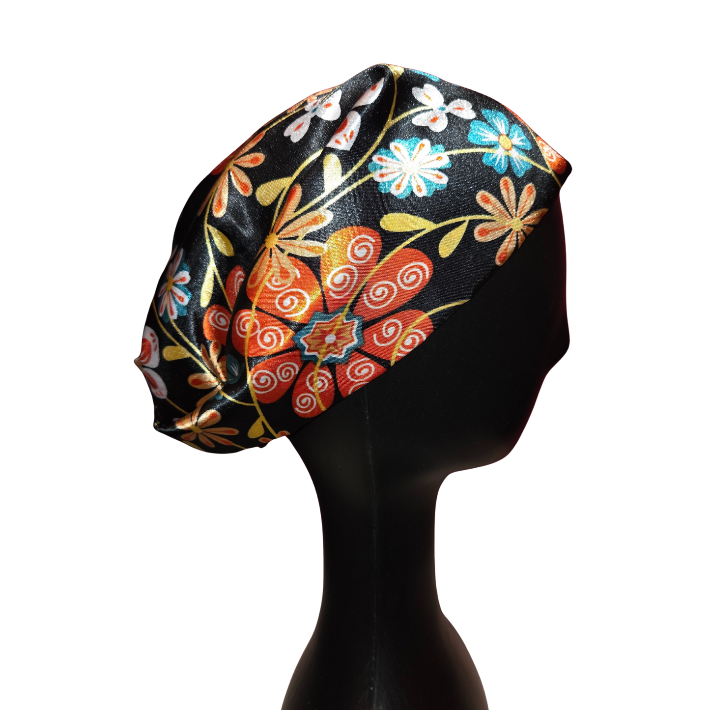 Colorful floral-patterned headscarf on a mannequin head against a white background