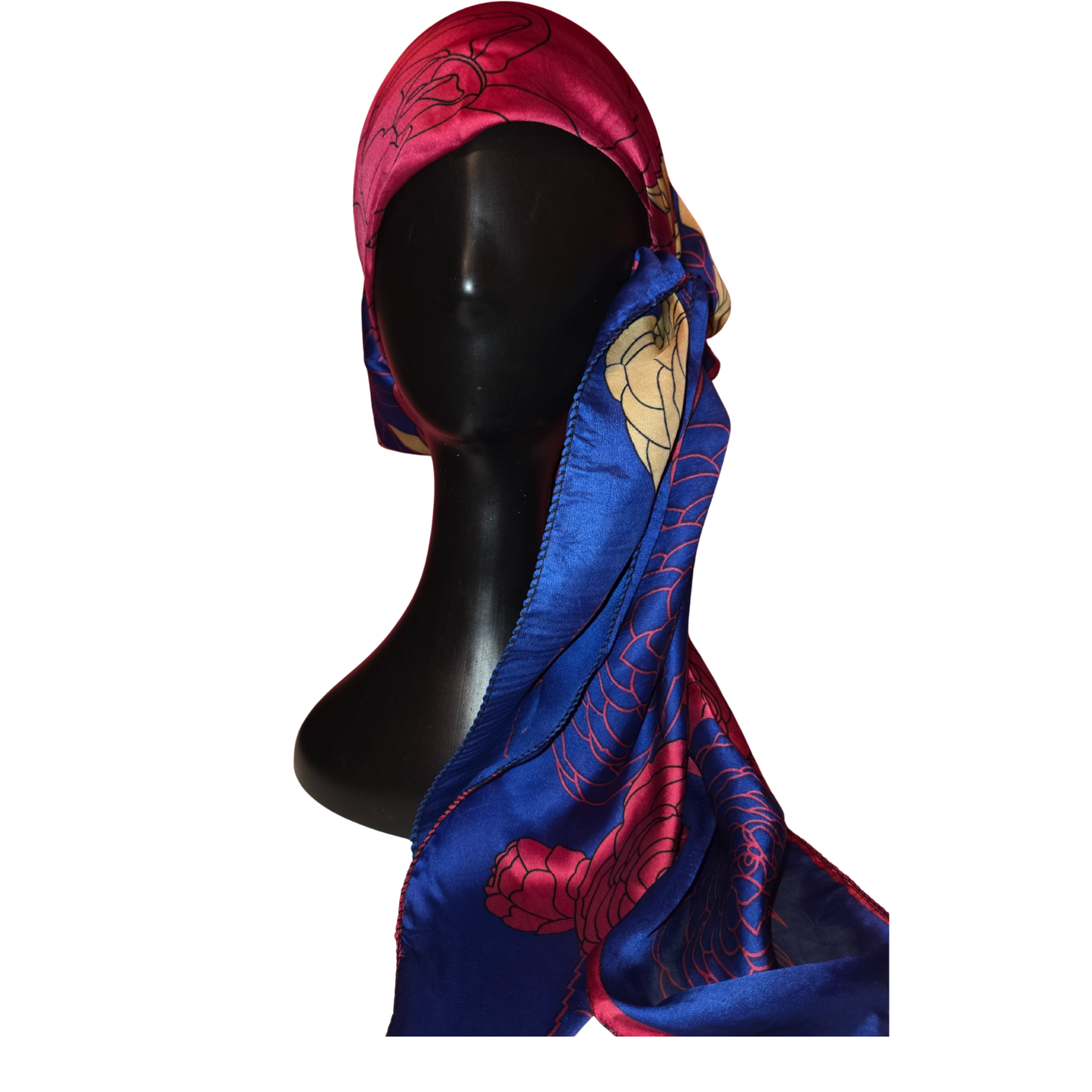 Mannequin head wearing a colorful scarf with intricate patterns on a white background