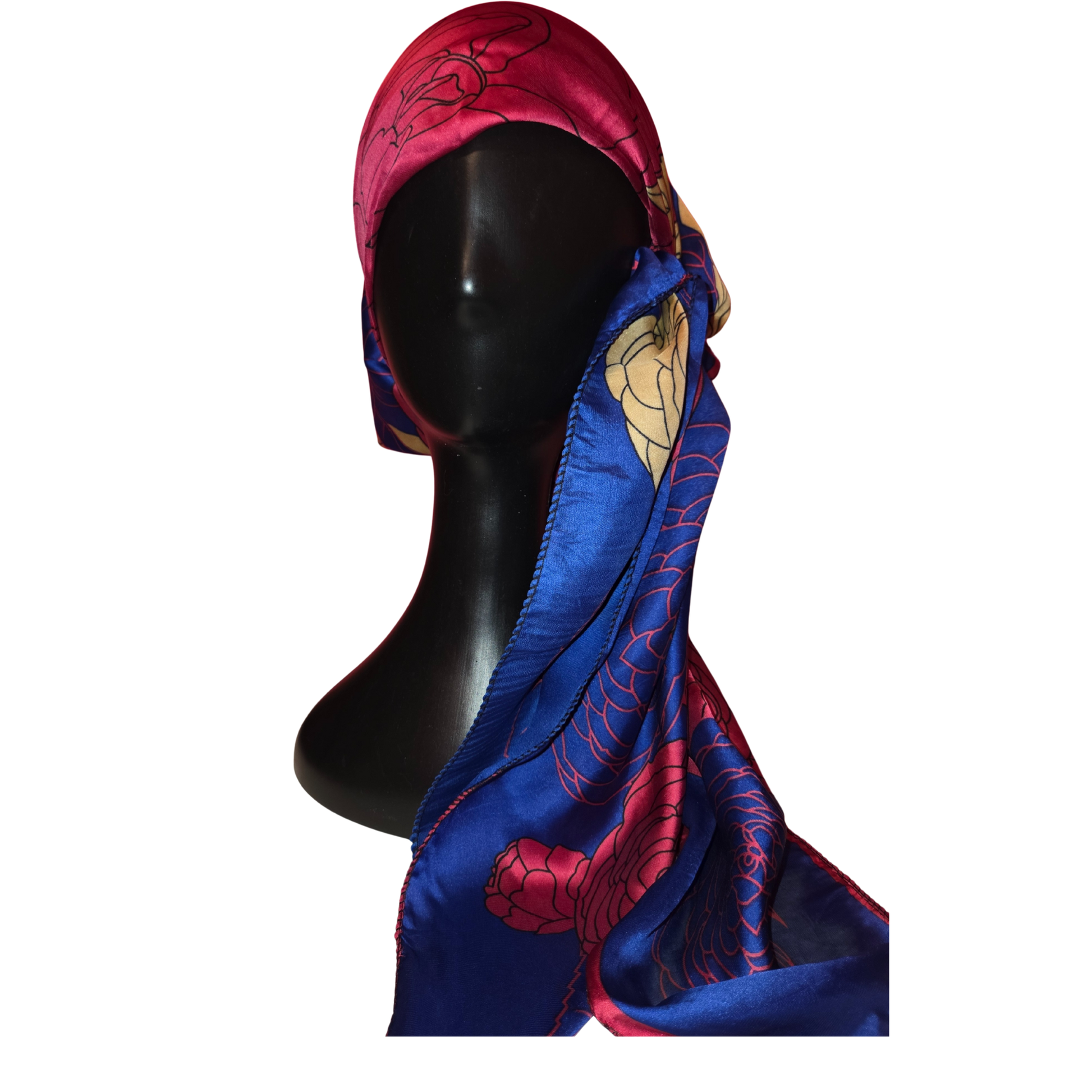 Mannequin head wearing a colorful scarf with intricate patterns on a white background
