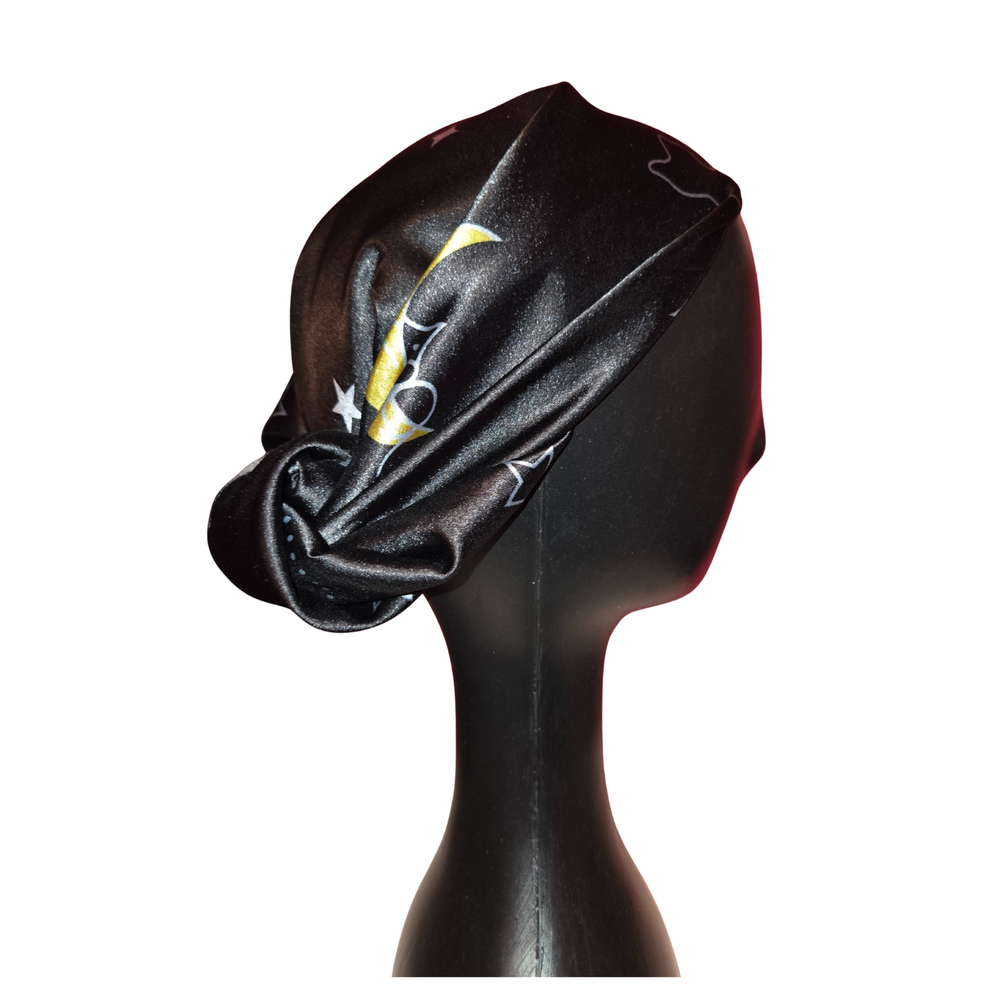 Black headscarf with a yellow design on a mannequin head against a white background