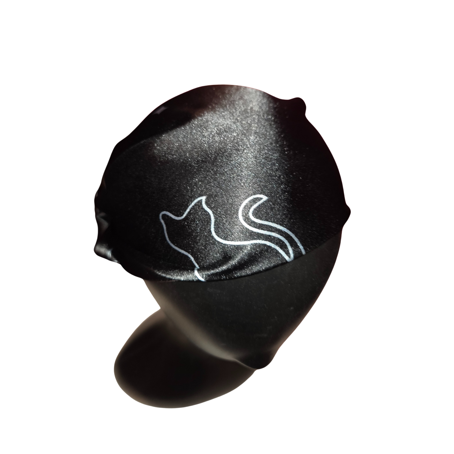 Black headband with white cat design on a white background