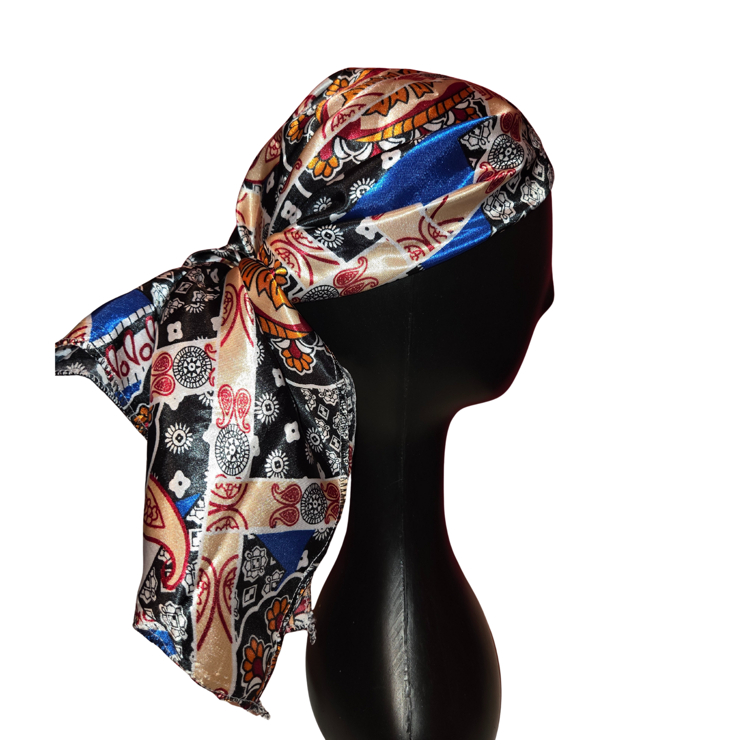 Colorful patterned headscarf on a black mannequin head against a white background