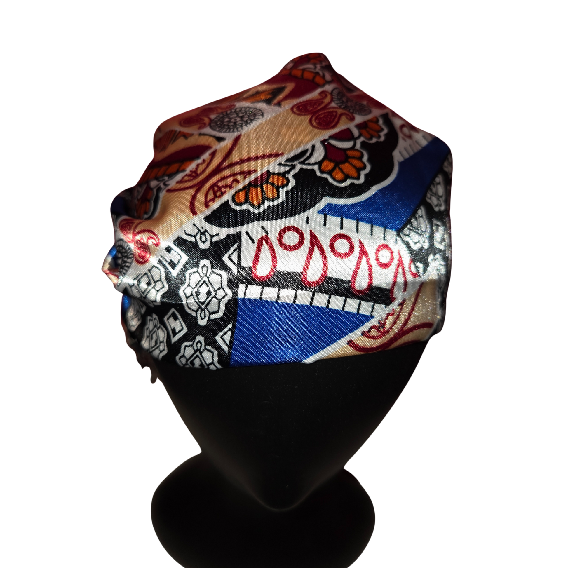 Colorful patterned headscarf on a mannequin head against a white background
