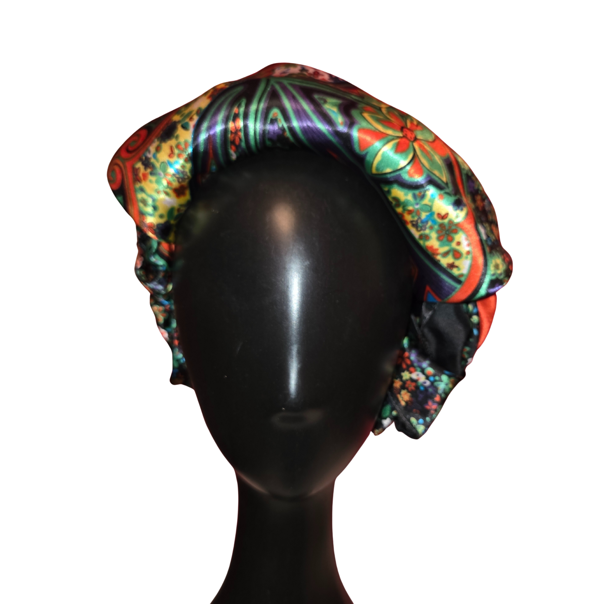 Colorful patterned headscarf on a black mannequin head against a white background