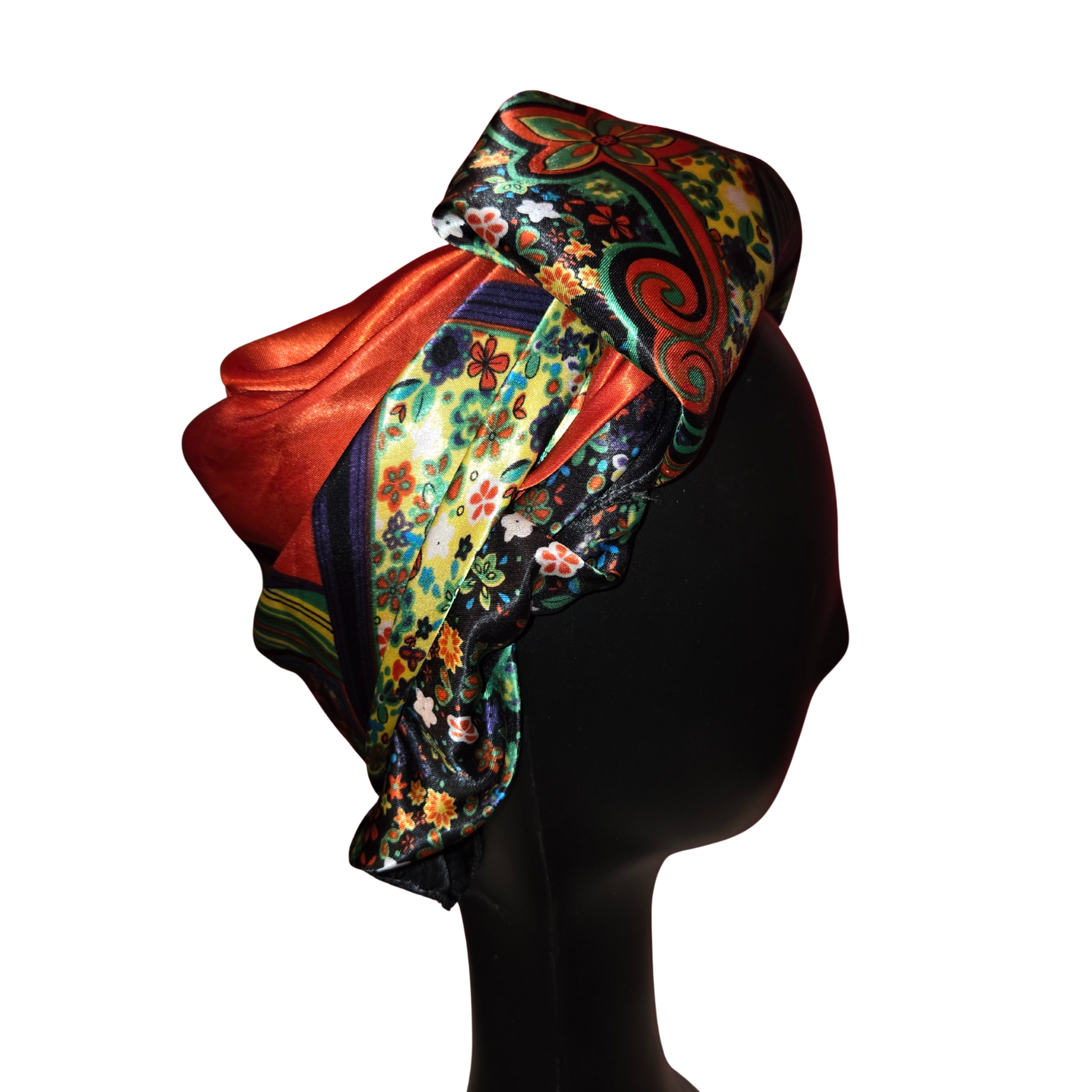 Colorful headscarf with floral patterns on a mannequin head against a white background
