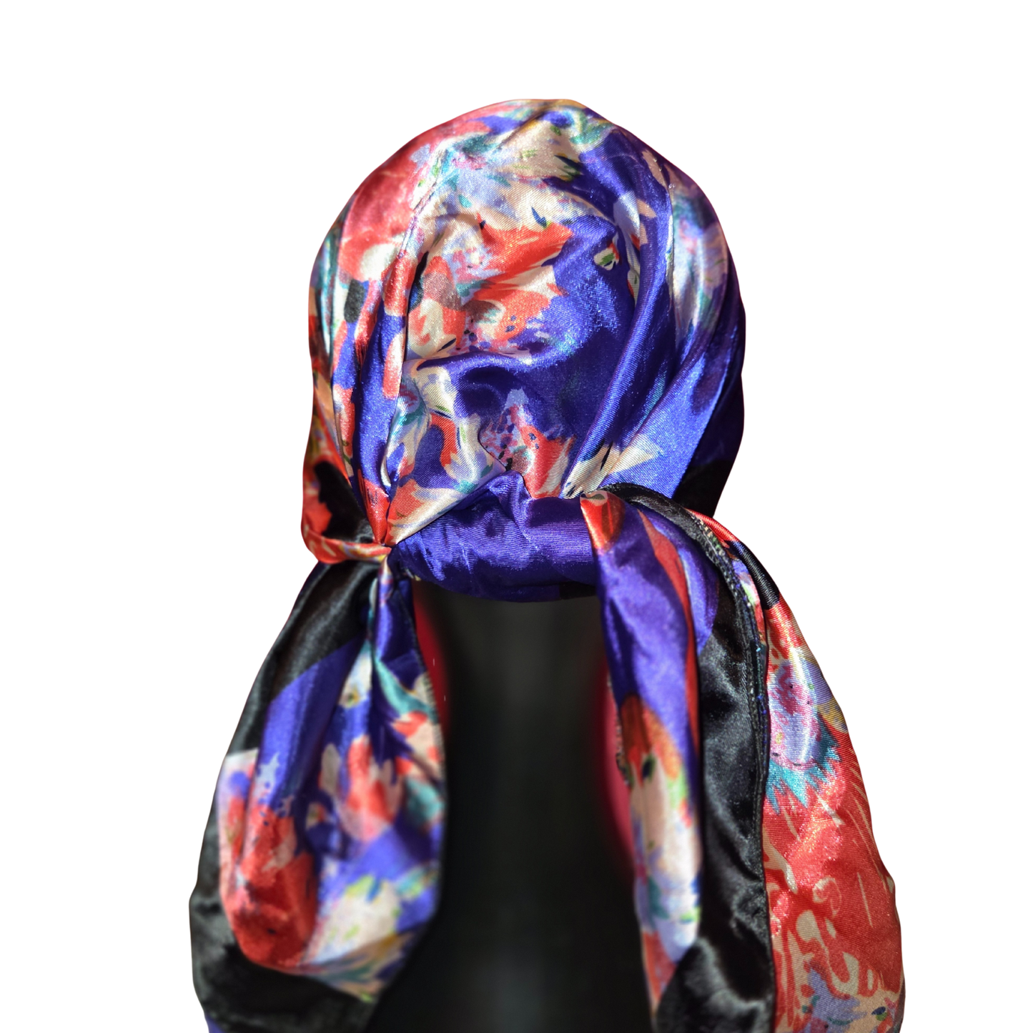 Colorful floral headscarf on a mannequin head against a white background