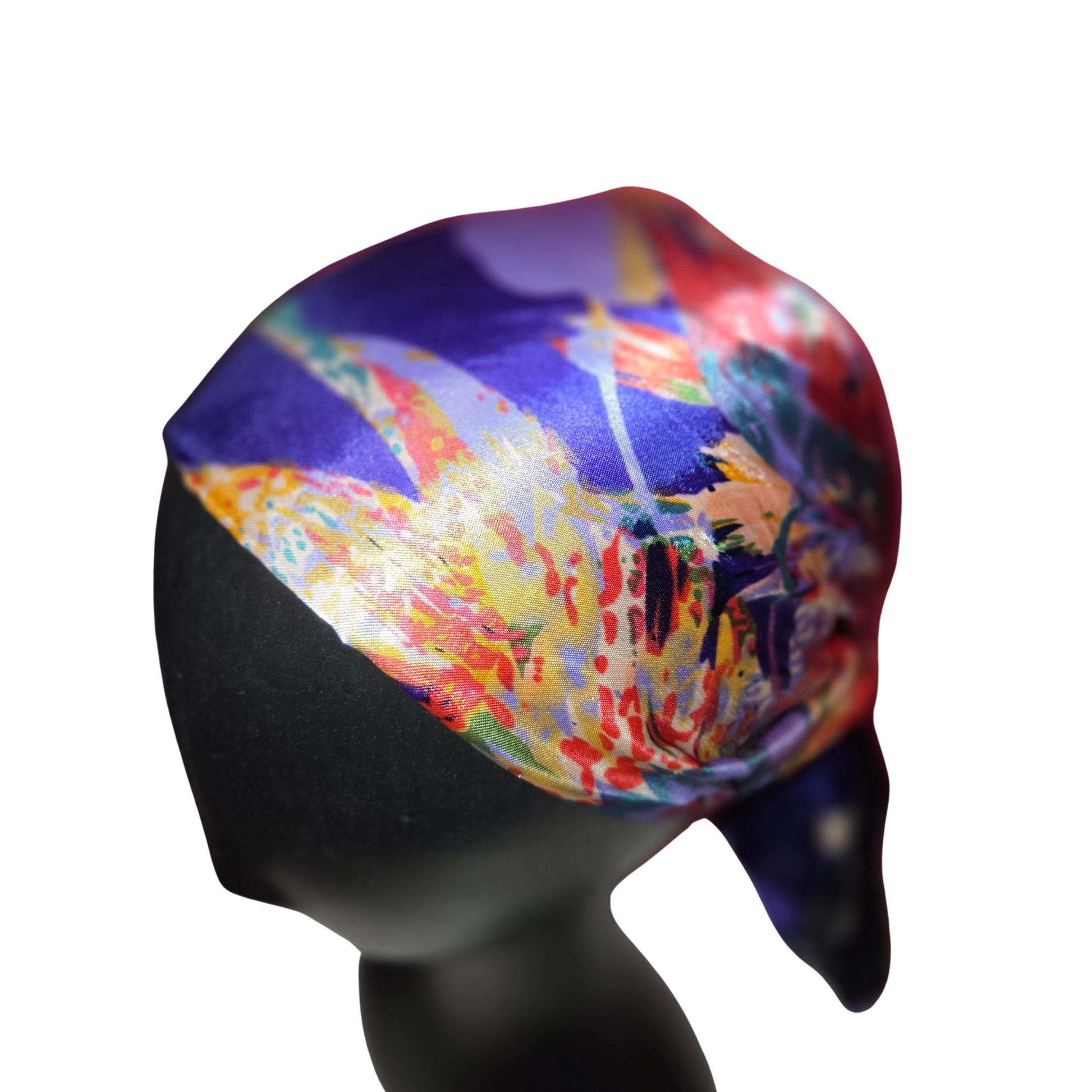 Colorful headscarf with abstract design on a mannequin head against a white background