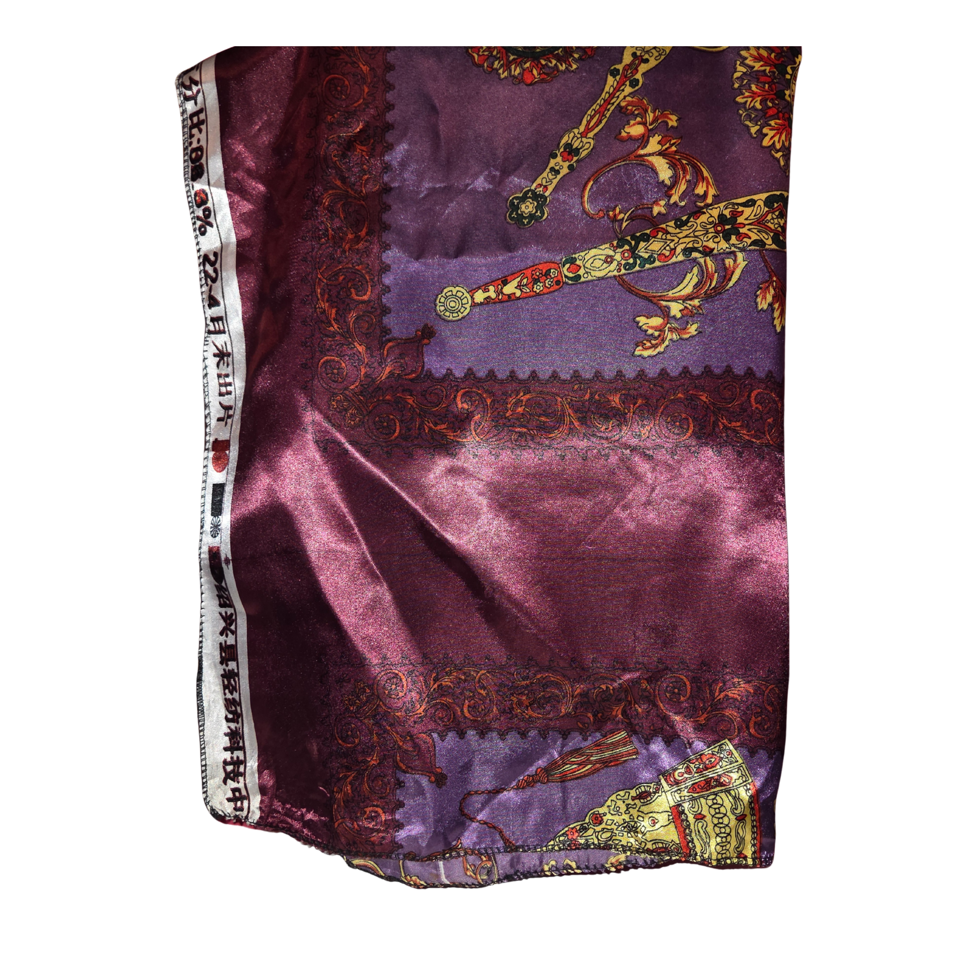Purple fabric with intricate gold and multicolor designs on a white background