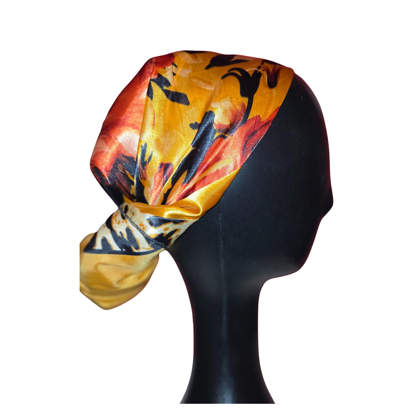 Colorful headscarf with abstract design on a black mannequin head against a white background