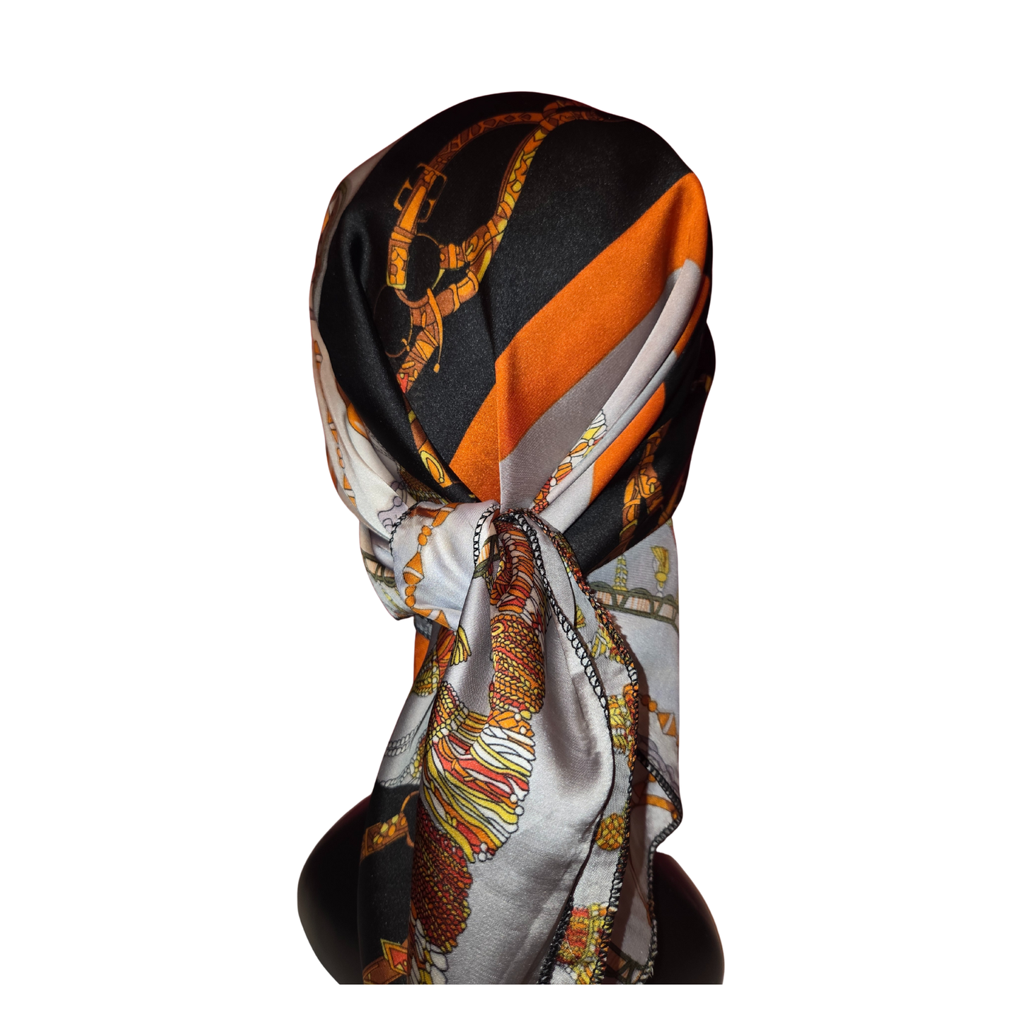 Colorful patterned scarf draped over a black surface on a white background