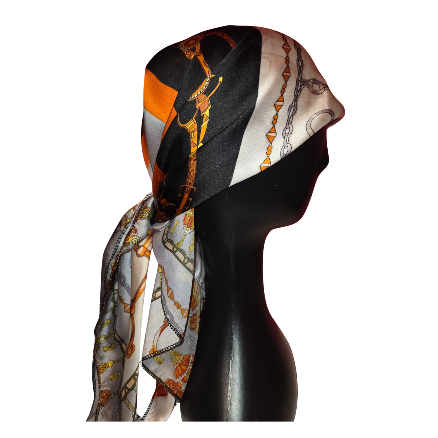 Mannequin head wearing a colorful scarf with black, orange, and white patterns on a white background