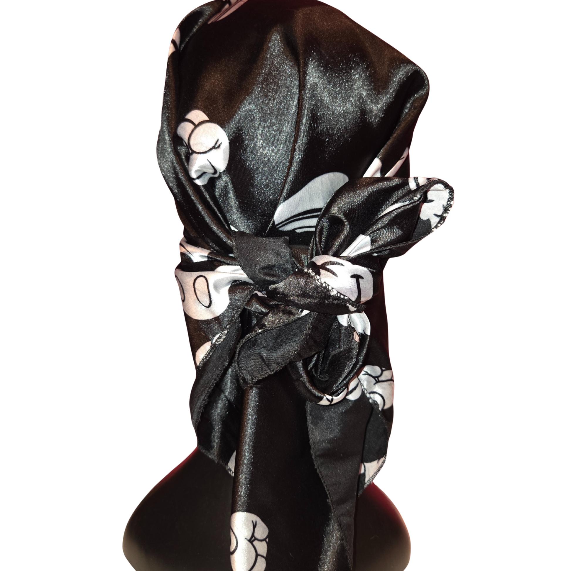 Black and white patterned headscarf on a mannequin head with a white background