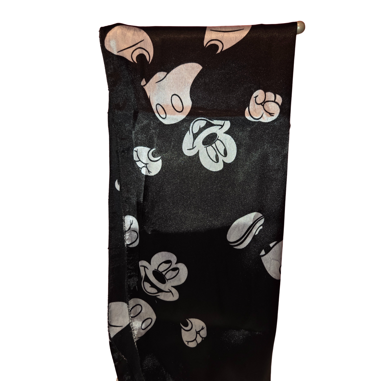 Black towel with white cartoon character faces on a white background