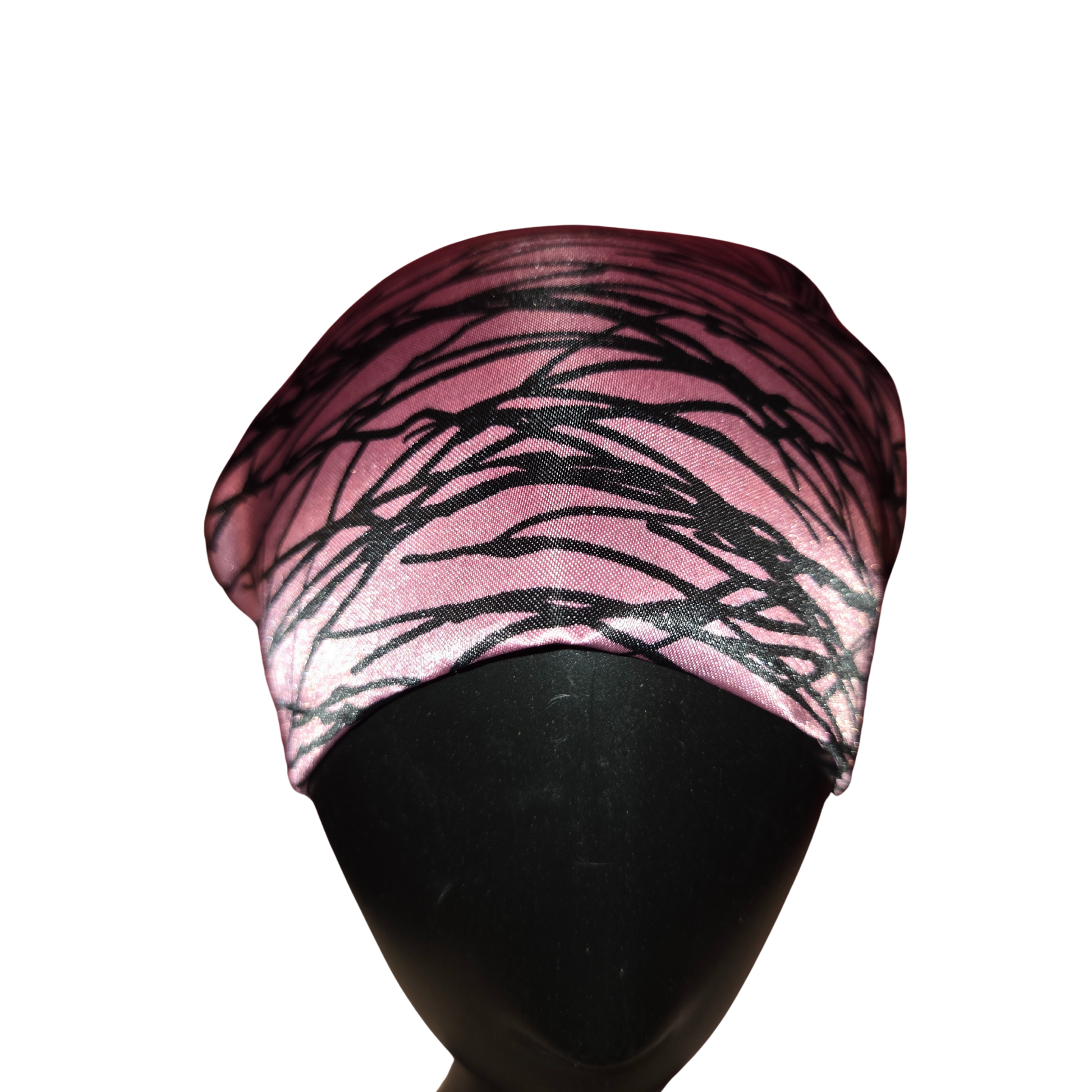 Pink headband with black abstract pattern on a mannequin head against a white background