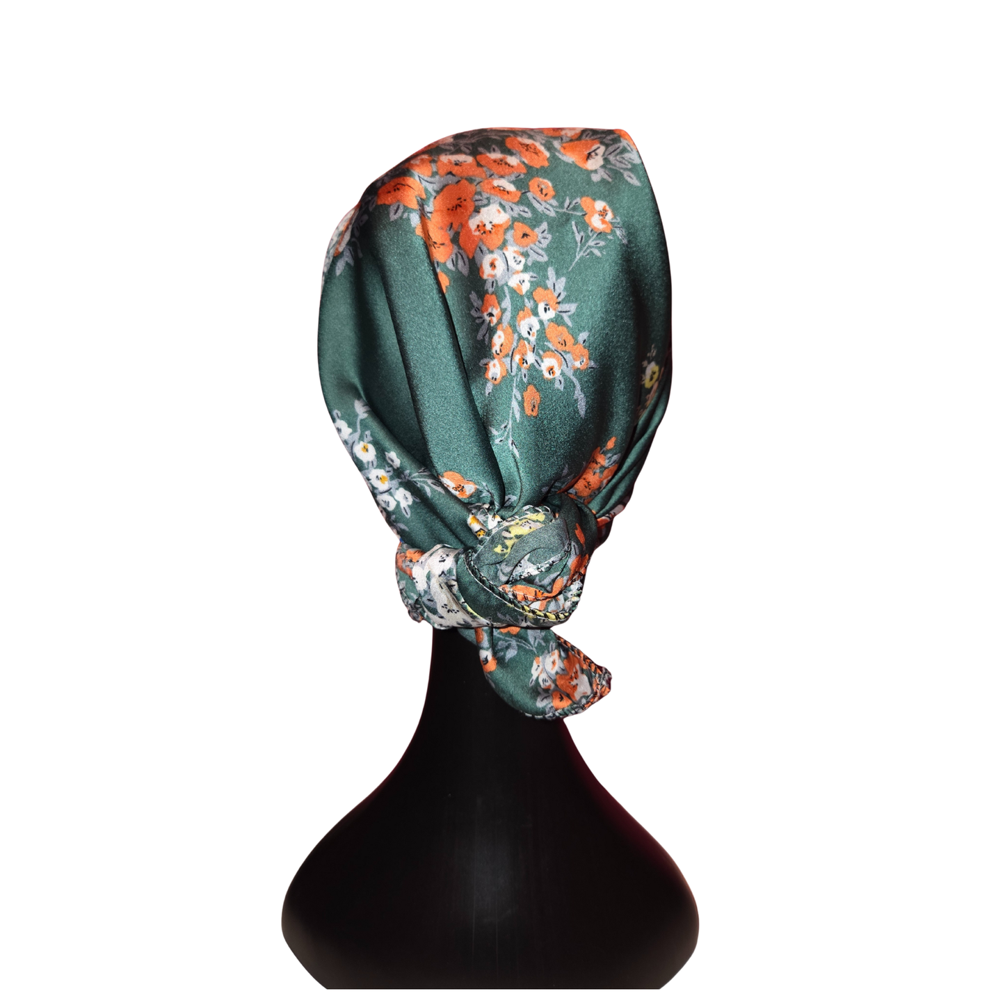 Floral headscarf on a black mannequin head against a white background